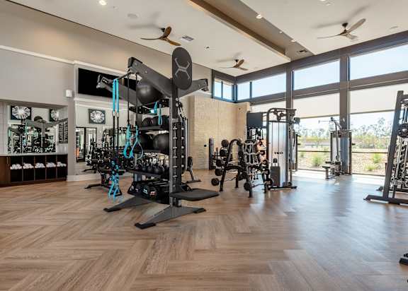 A gym with a variety of equipment including weights and machines.