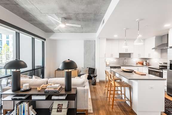 A modern kitchen with white cabinets and a large island.