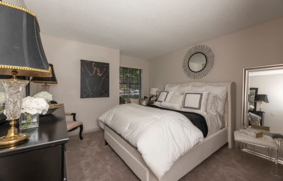 a bedroom with a bed and a dresser and a window