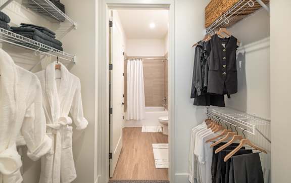 A hallway with a white door and a towel hanging on the wall.