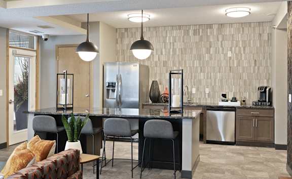 A modern kitchen with a dining table and chairs.