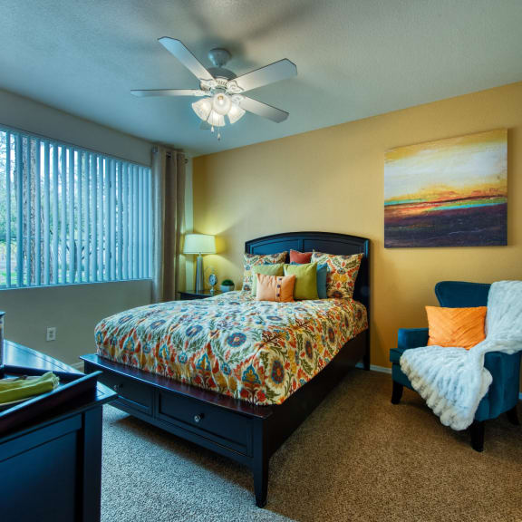 a bedroom with a bed and a ceiling fan
