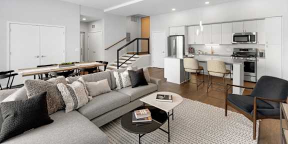 A modern living room with a grey sofa and a coffee table.