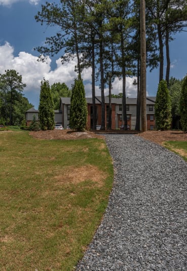 a view of a house from a gravel driveway