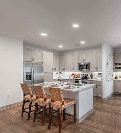 A modern kitchen with a dining table and chairs.