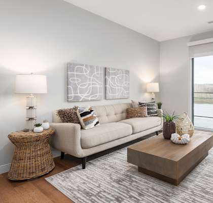 a living room with a couch and a coffee table at The Flats & Terraces at Wildhorse Village, Chesterfield Missouri