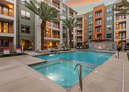 A swimming pool in front of apartment buildings.