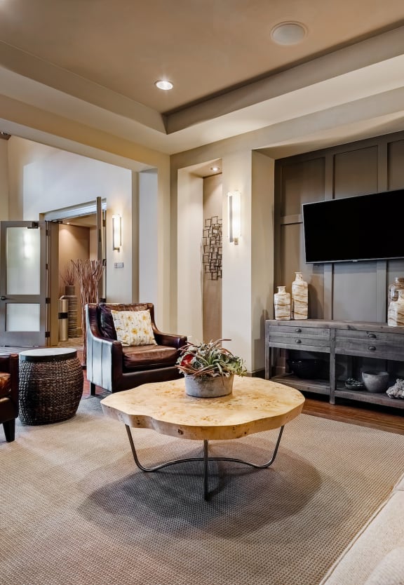 a living room filled with furniture and a flat screen tv