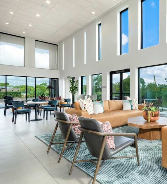 A living room with a couch, chairs, and a coffee table.