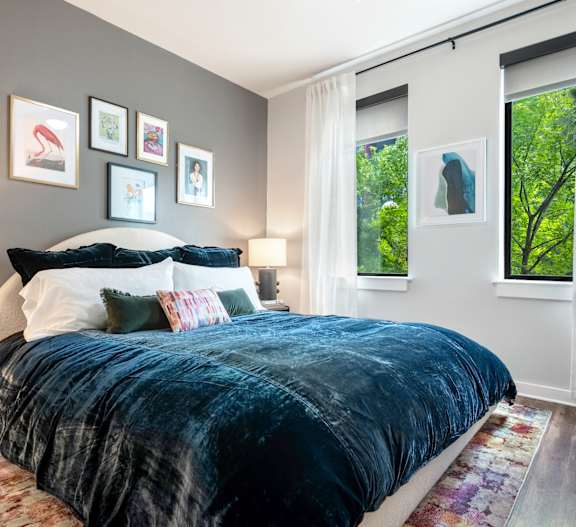 Stylish Bedroom Featuring Minimalist Decor and Plush Carpet at Lamar Union
