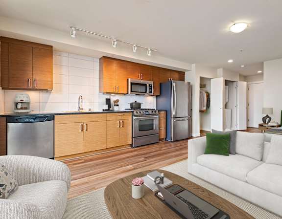 A modern kitchen with wooden cabinets and stainless steel appliances.