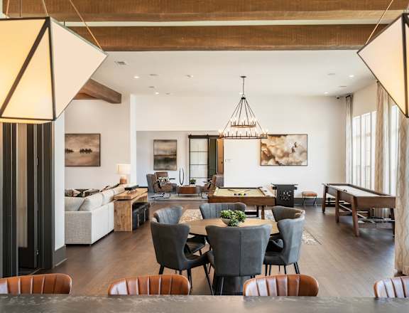 a dining room and living room with a table and chairs