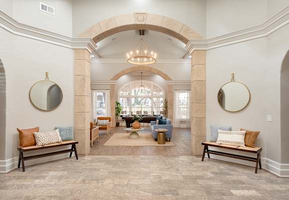 a living room with an arched ceiling and a lobby with seating and a table  at Hayden on West Ave, San Antonio, 78216