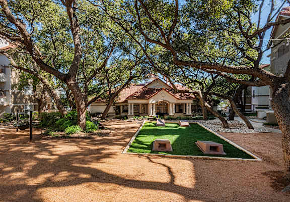 a courtyard with grass and trees in front of a house  at Hayden on West Ave, San Antonio, Texas