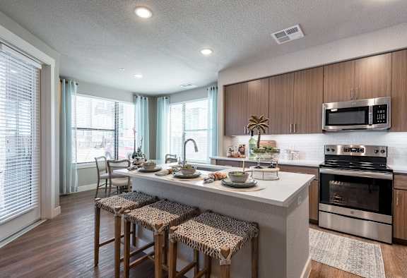 A kitchen with a white countertop and stainless steel appliances.