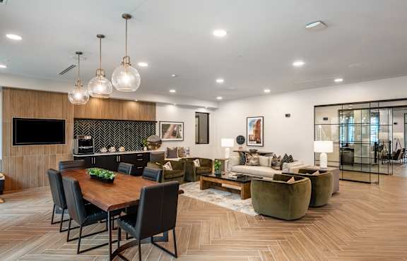 A modern living room with a wooden dining table and chairs.