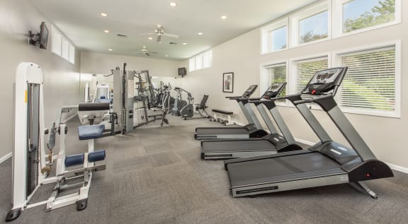 a gym with cardio machines and a ceiling fan at Highland Ridge Apartments, Overland Park , KS 66210