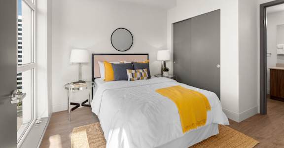 a bedroom with a large bed and a door to a bathroom