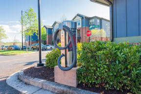 a sculpture in front of a building with a stop sign