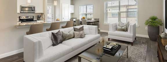 A modern living room with a white sofa and a glass coffee table.