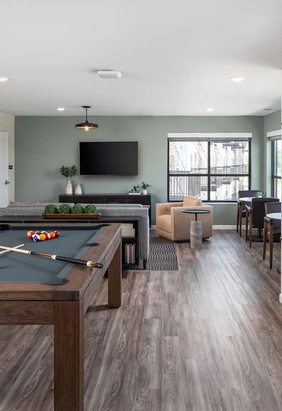 a games room with a pool table and a tv