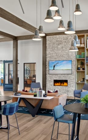 a living room with tables and chairs and a fireplace