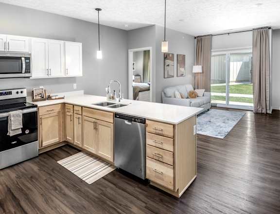 A modern kitchen with wooden cabinets and a large island.