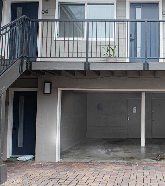 A small pool in a courtyard surrounded by apartment buildings.