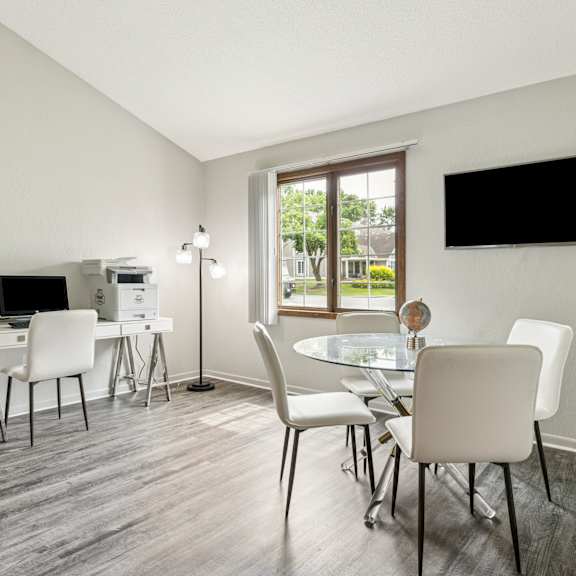 A living room with a couch, chair, and coffee table. at Seasons Villas Apartments, Woodbury, MN, 55125
