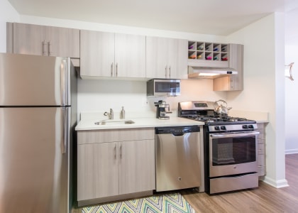 Modern Kitchen With Custom Cabinet of Amberleigh apartments and townhomes with walkways and surrounded by trees and greenery in Fairfax, Virginia 22031