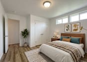 Thumbnail 8 of 8 - A bedroom with a bed, a plant, and a lamp.