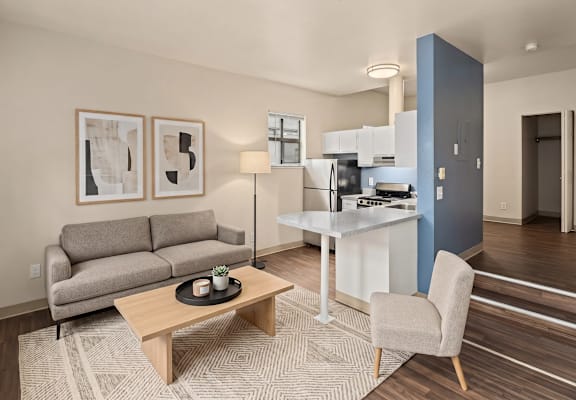 A living room with a couch, a coffee table, and a chair.