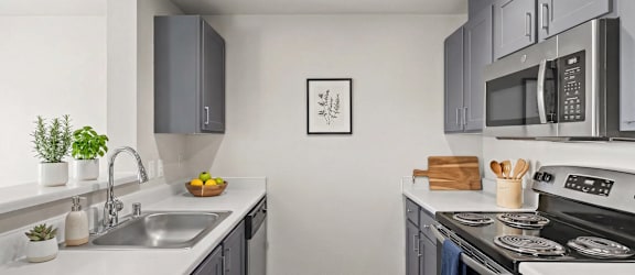 A modern kitchen with a stainless steel oven and microwave.