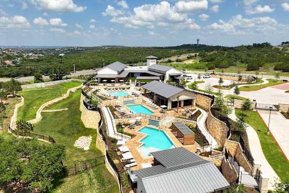 A large house with a pool and a hot tub.