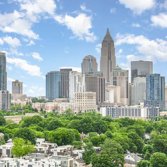 Skyline of city with blue sky behind it. 
