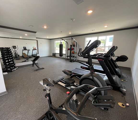 A spacious gym with a variety of exercise equipment.
