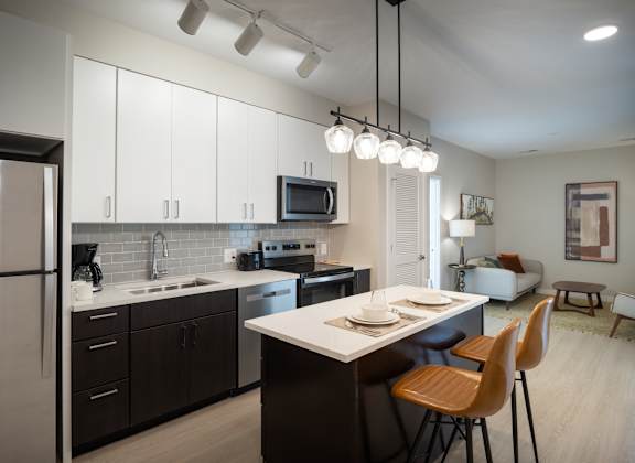 A modern kitchen with a dining table and chairs.
