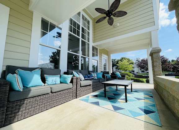 a covered porch with couches and a coffee table at The Chase, Burlington, NC