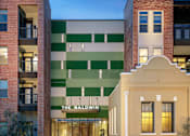 Thumbnail 4 of 31 - Street-level view of an The Baldwin building with a mix of exterior materials, balconies, and landscaped edges