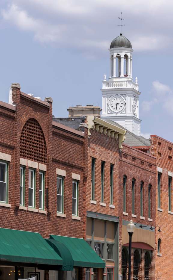 Brick buildings and a clock tower in downtown Independence, Missouri.
