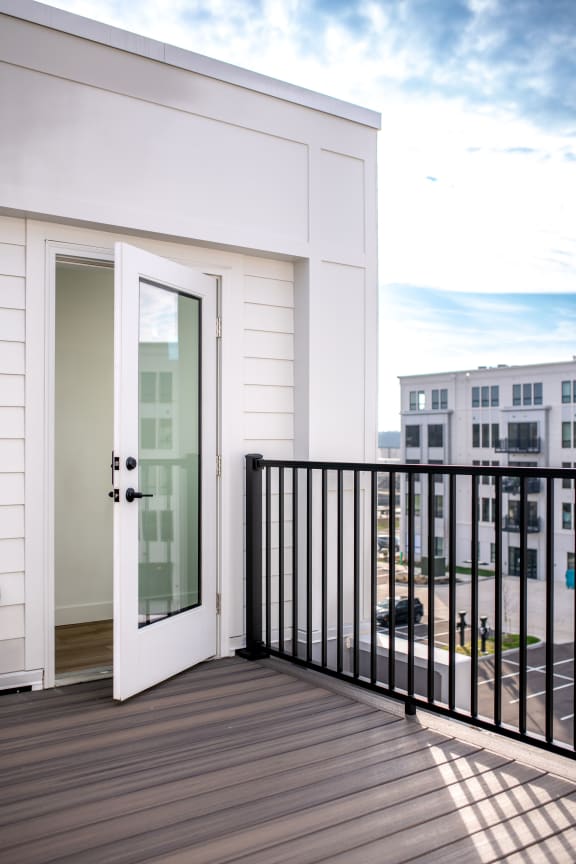 a balcony with a door and a view of the city