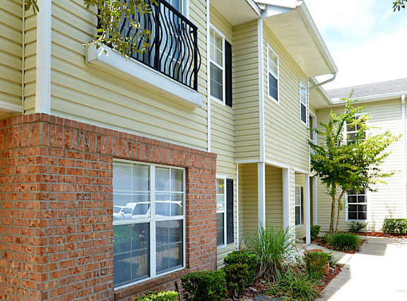 A row of houses with a brick wall and a window.
