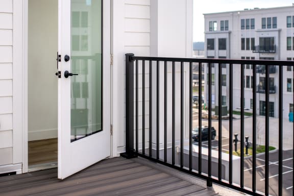 a balcony with a door and a view of the city