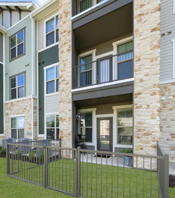 a metal fence in front of an apartment building at North Creek, Texas, 78634
