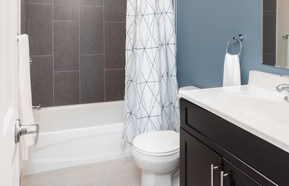 a bathroom with a toilet and a shower and a sink at Cherry Street Lofts in Bridgeport, CT, 06605