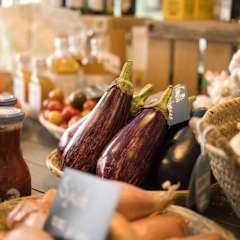 a display of eggplant and other produce at a farmers market