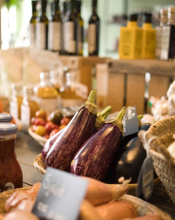 a display of eggplant and other produce at a farmers market