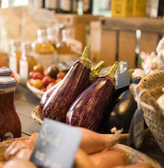 a display of eggplant and other produce at a farmers market