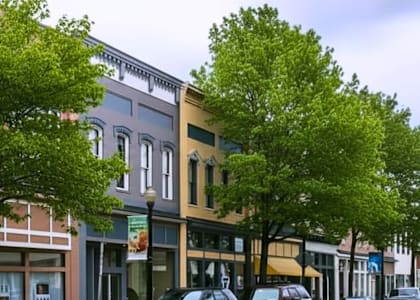 A street view of a small town with cars parked on the side of the road.