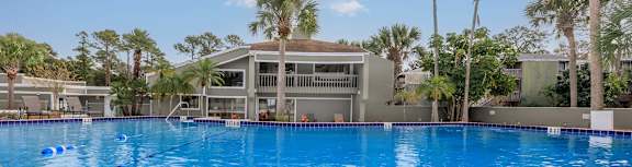A modern house with a balcony and a patio area.